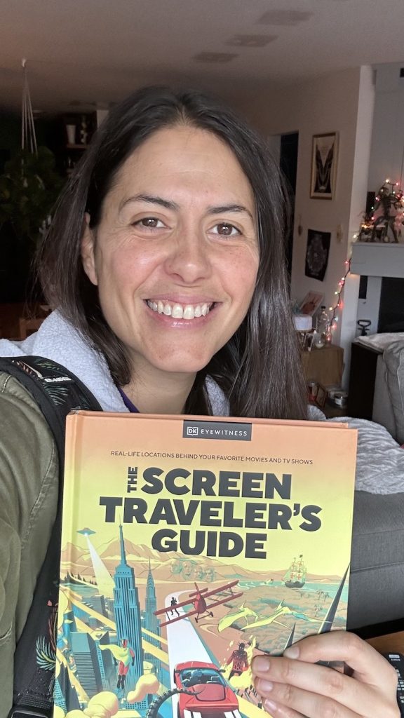 GemandSTG Gem Seddon grinning like a dork holding a copy of The Screen Travelers Guide book