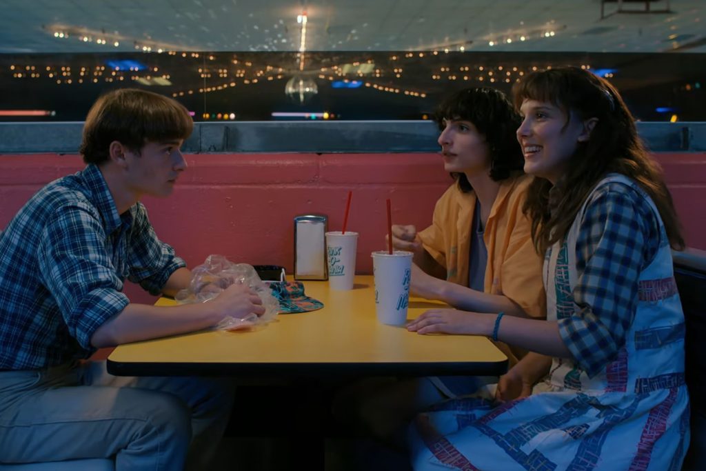 Eleven, Mike, and Will at the Rink-O-Mania roller skating rink in Stranger Things Season 4.