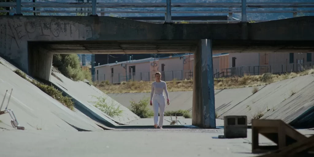 Eleven emerging from the arroyo at the park in Stranger Things Season 4.