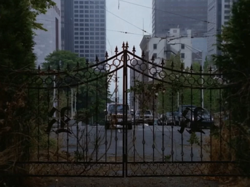 Jimmi Simpson approaches the Rose Red mansion gates from a different angle at Spring Street and 7th Avenue in Seattle.
