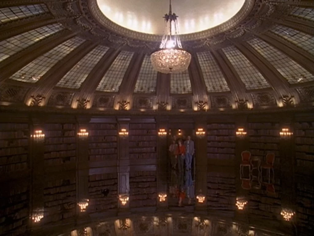 The group stands together inside the ornate Mirror Library during their first encounter with the room in Rose Red.